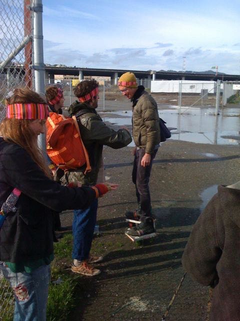 AW on book-skates, MS with supply pack, all wearing head- and wristbands.